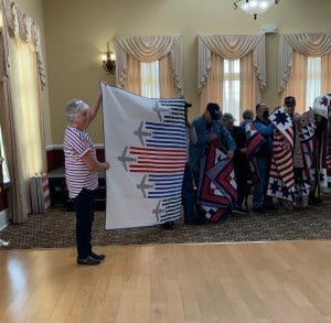 Homeowner holding quilt